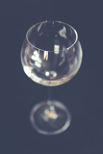 Empty wine glass on dark background with bokeh