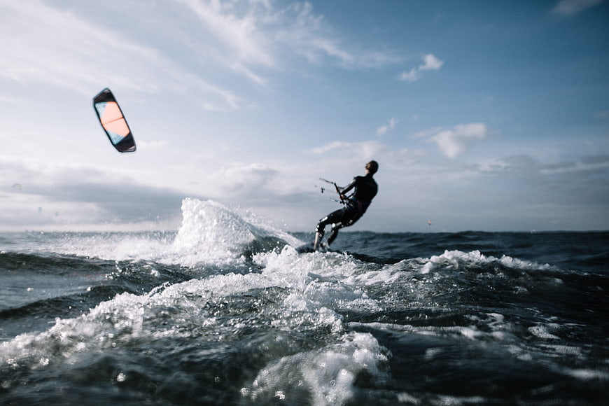 Kite Surfer Riding Ocean Waves with Splash