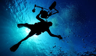 Silhouette of Scuba Diver Underwater with Camera Rig