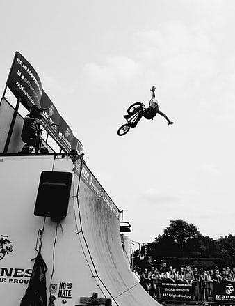 BMX Rider Performing Aerial Stunt on Halfpipe Ramp