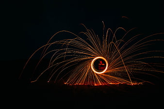 Steel wool photography creating sparks and light trails at night
