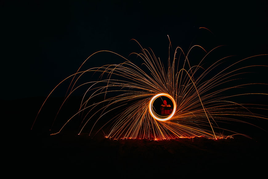 Steel wool photography creating sparks and light trails at night