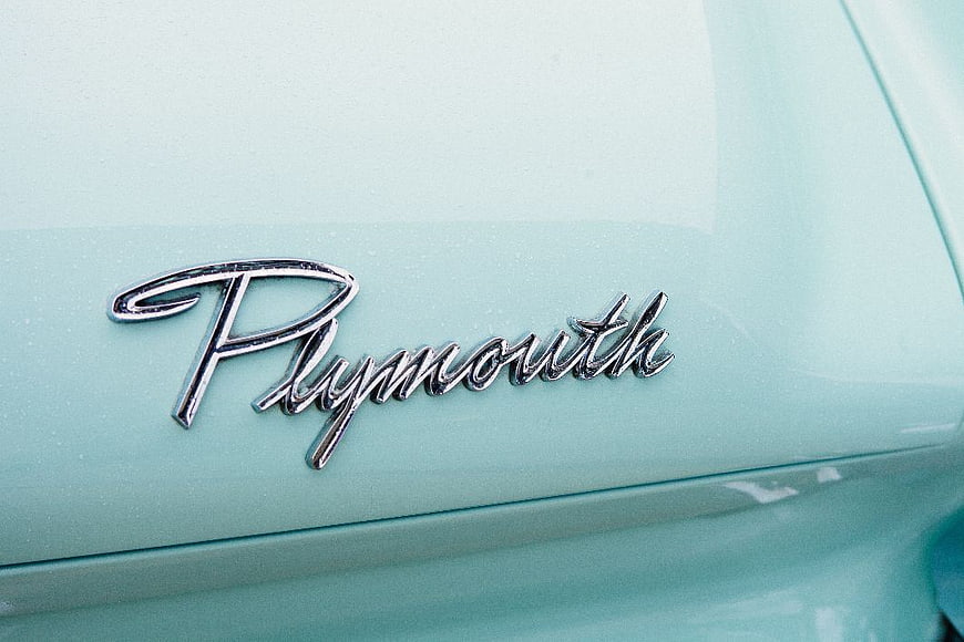 Close-up of Vintage Plymouth Car Emblem on Mint Green Paint