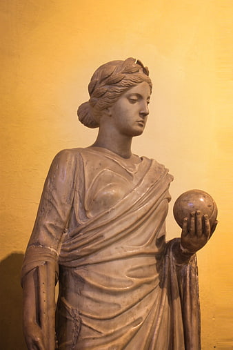 Classical marble statue of woman holding sphere