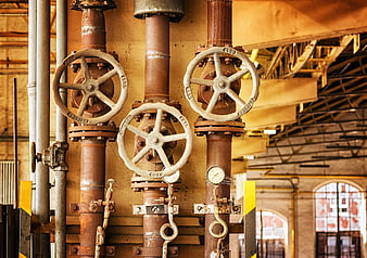 Rusty Industrial Pipes and Valves in Old Factory