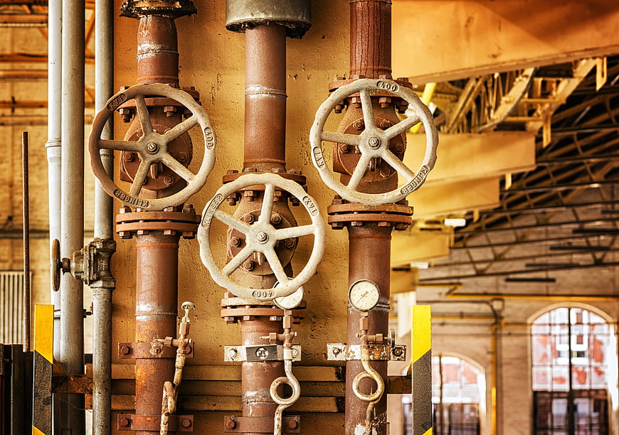 Rusty Industrial Pipes and Valves in Old Factory