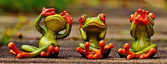 Three ceramic frogs in see no evil, hear no evil, speak no evil poses