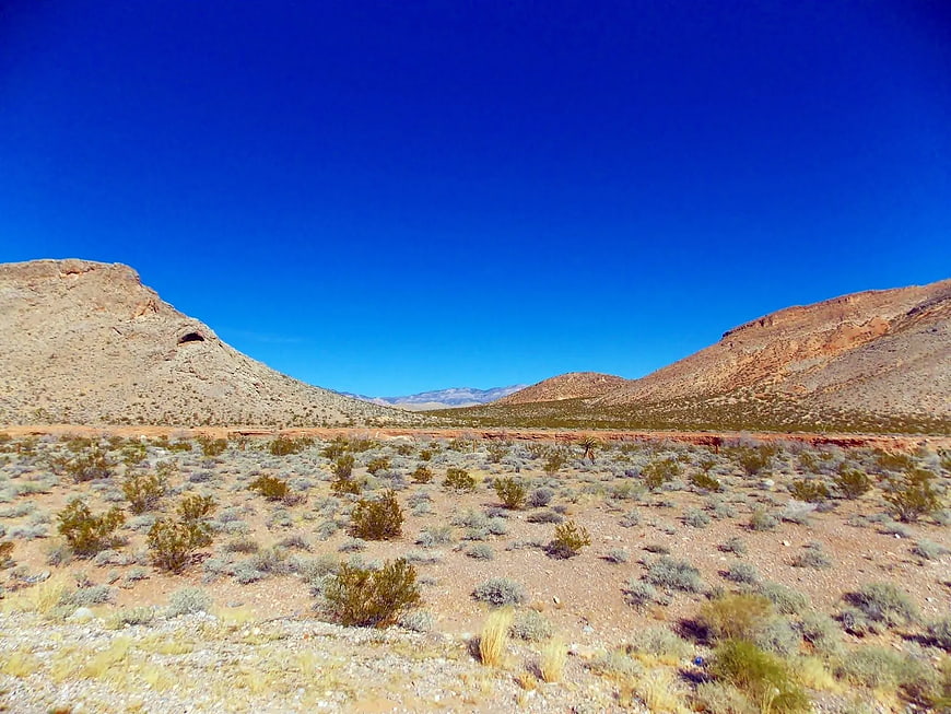 Wide desert valley landscape with blue sky and scrub brush