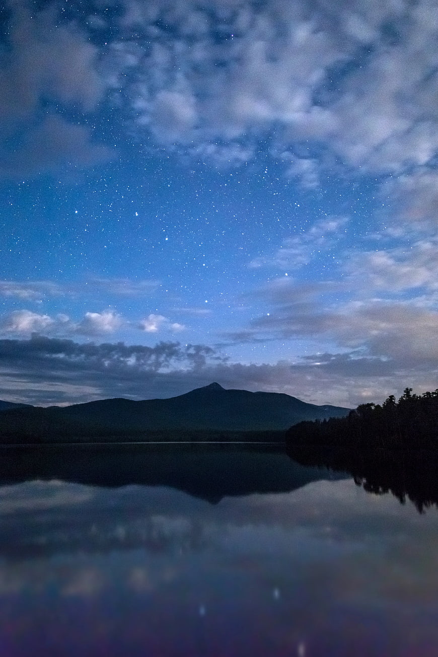Starry Night Sky Over Mountain Lake Reflection
