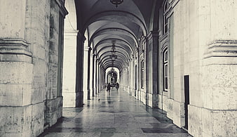 Perspective of historic stone arcade corridor in Lisbon