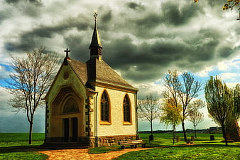 Small Gothic Chapel in Eifel, Germany Under Dramatic Sky