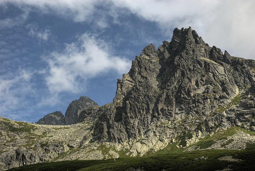 Dramatic Rocky Mountain Peak with Blue Sky and Clouds