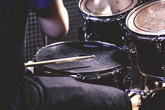 Close-up of Drummer Playing Drums with Drumsticks