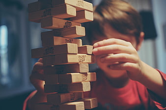 Child Playing Jenga Wooden Block Tower Game