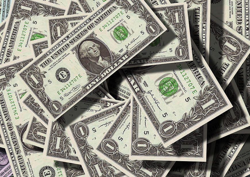 Scattered US One Dollar Bills with Dramatic Shadows