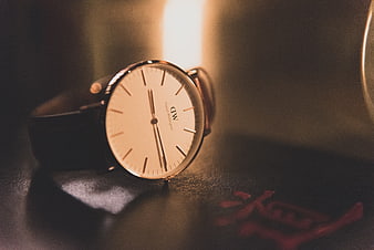 Minimalist Daniel Wellington Watch on Dark Leather Surface