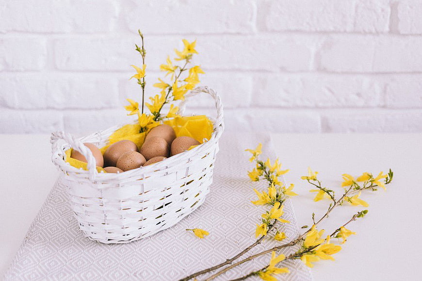 White Basket with Brown Eggs and Yellow Spring Flowers
