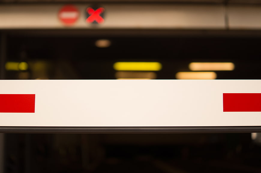 Red and White Parking Barrier Gate with Blurred Background