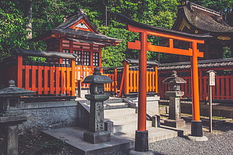 Traditional Japanese Shinto Shrine with Red Torii Gate