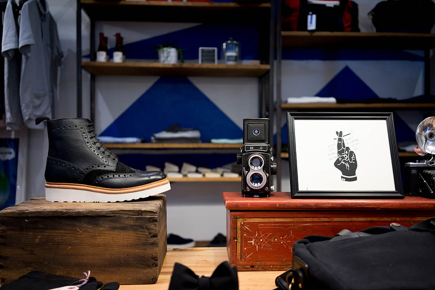Black leather brogue shoe display in vintage shop