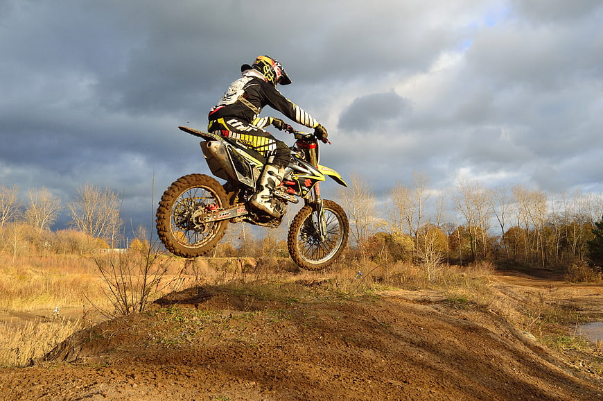 Motocross Rider Jumping Dirt Bike on Outdoor Track