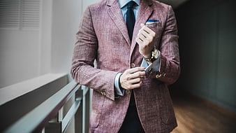 Businessman in Pink Blazer Checking Watch and Phone