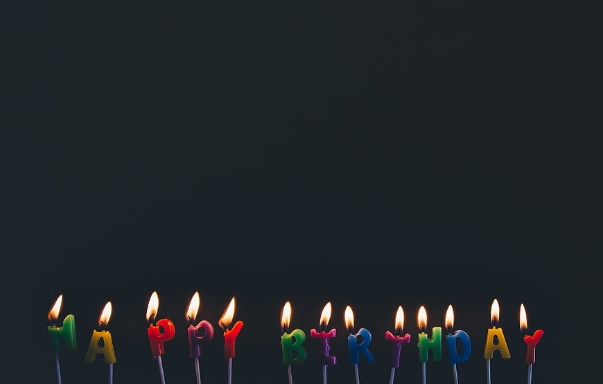Happy Birthday Letter Candles on Dark Background