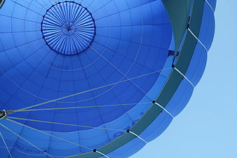 Low angle view of blue hot air balloon interior against sky