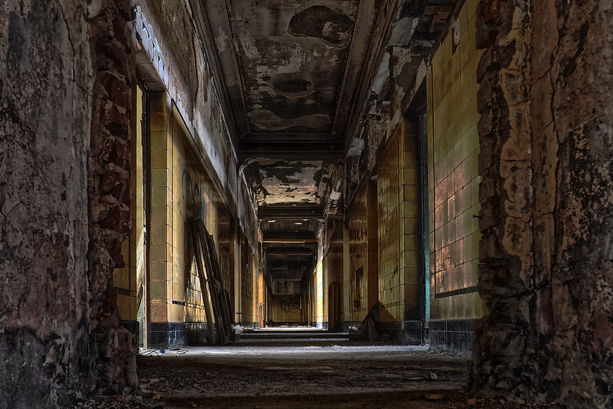 Decaying Abandoned Corridor with Peeling Paint and Yellow Tiles
