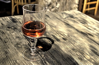 Glass of Rosé Wine on Rustic Wooden Table