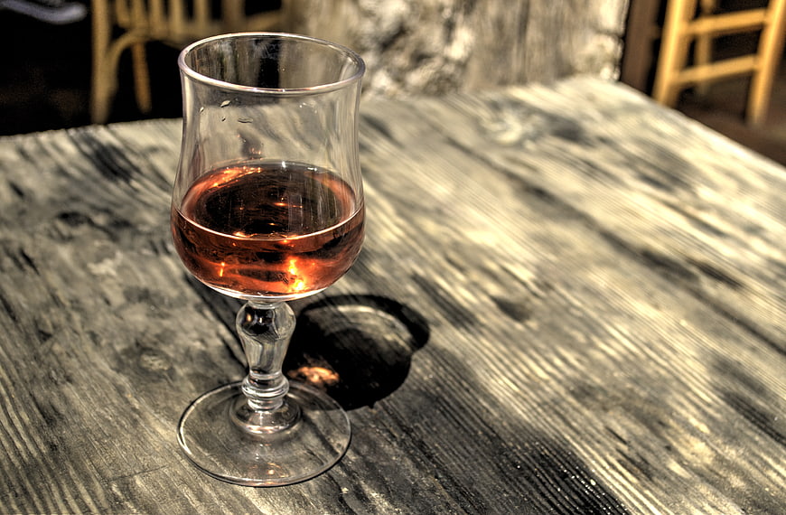Glass of Rosé Wine on Rustic Wooden Table