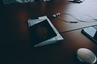 Canadian passport and travel documents on wooden table