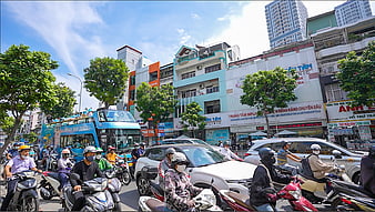 Busy street traffic in Vietnam with motorbikes and blue bus
