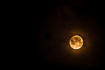 Full Orange Moon in Dark Night Sky with Clouds
