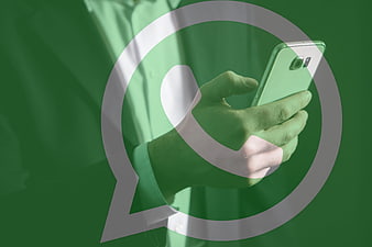 Hand holding smartphone with WhatsApp logo overlay