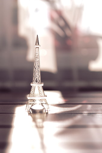 Glass Eiffel Tower Souvenir on Wooden Table