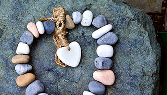 Handmade Stone Heart Necklace on Textured Rock Background