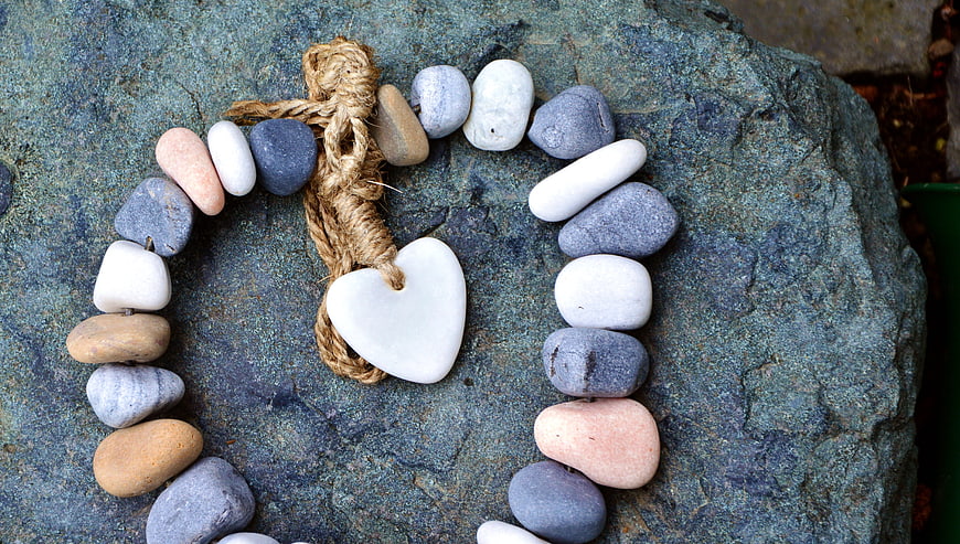Handmade Stone Heart Necklace on Textured Rock Background