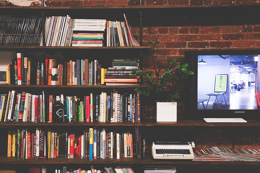 Vintage Office Workspace with Books, Typewriter, and Monitor