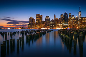 New York City Skyline at Dusk with Wooden Pilings