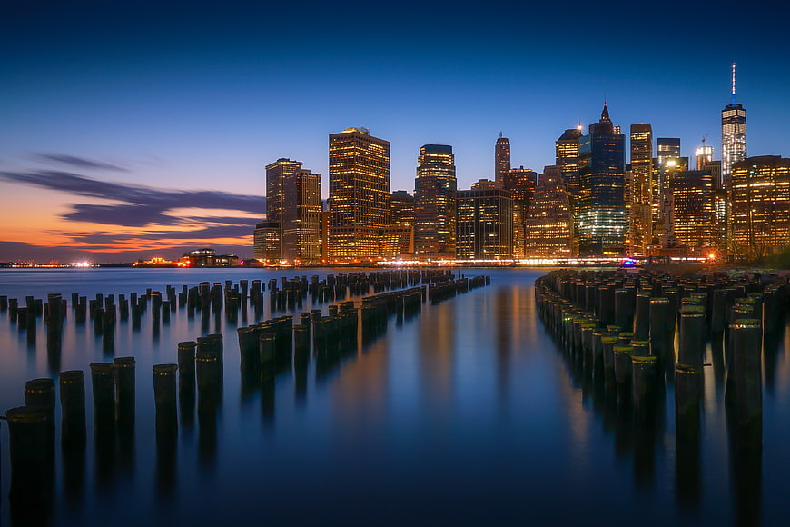 New York City Skyline at Dusk with Wooden Pilings