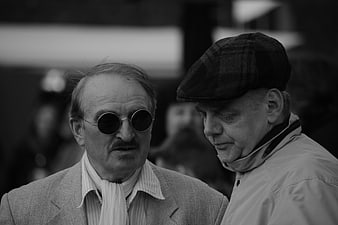 Two Men In Conversation Wearing Vintage Accessories