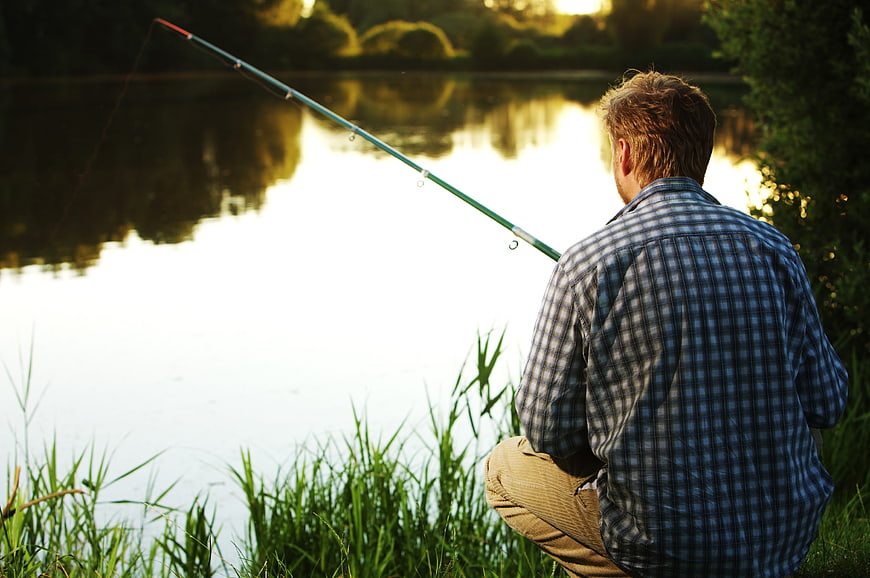Man Fishing at Sunset by Lake