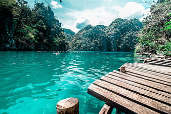 Turquoise Lagoon with Wooden Dock and Limestone Cliffs