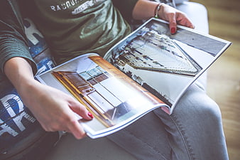 Person reading architecture magazine on lap