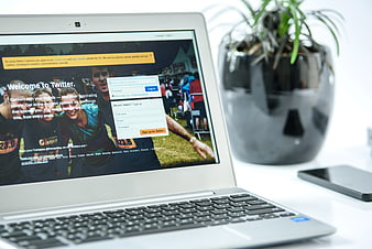 Laptop displaying Twitter login page on white desk