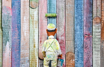 Miniature painter figure painting colorful rustic wooden wall background