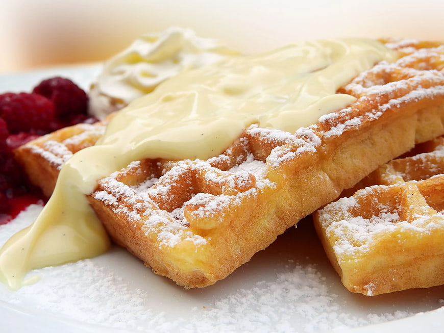 Golden Waffles with Cream, Raspberries, and Powdered Sugar