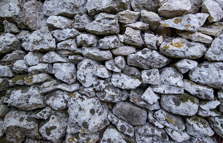 Textured Stone Wall Background with Lichen and Moss