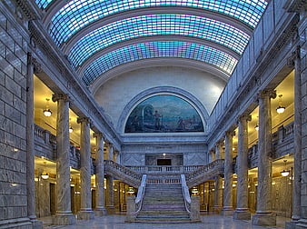 Grand marble interior of a historic courthouse with stained glass ceiling